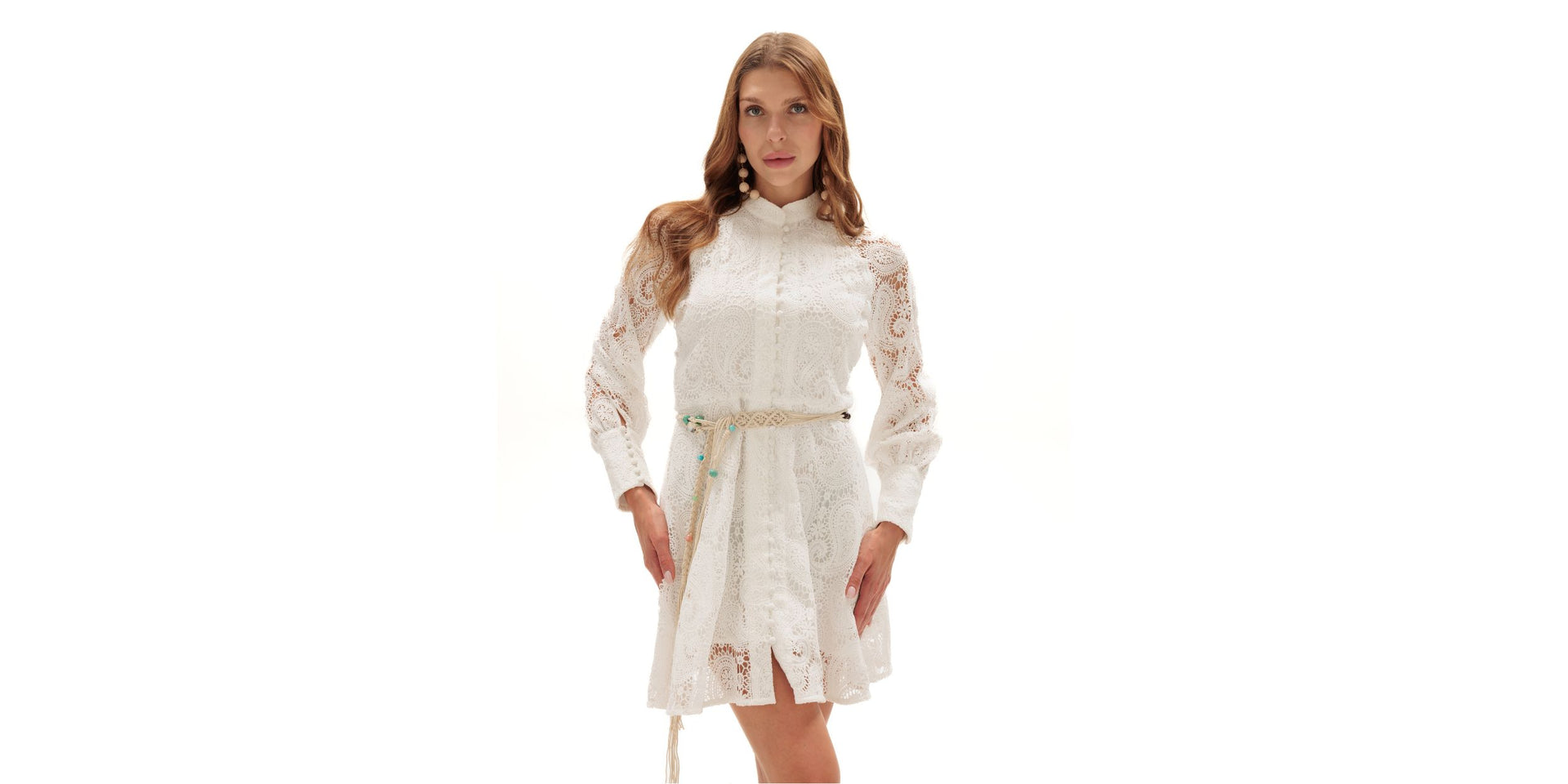 Woman wearing a white lace dress on a white background