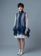 Woman wearing Shore Darling sustainable Chiffon Cloud Tunic & Bubble Skirt 2-Piece Set with a sheer dark blue vest and white dress