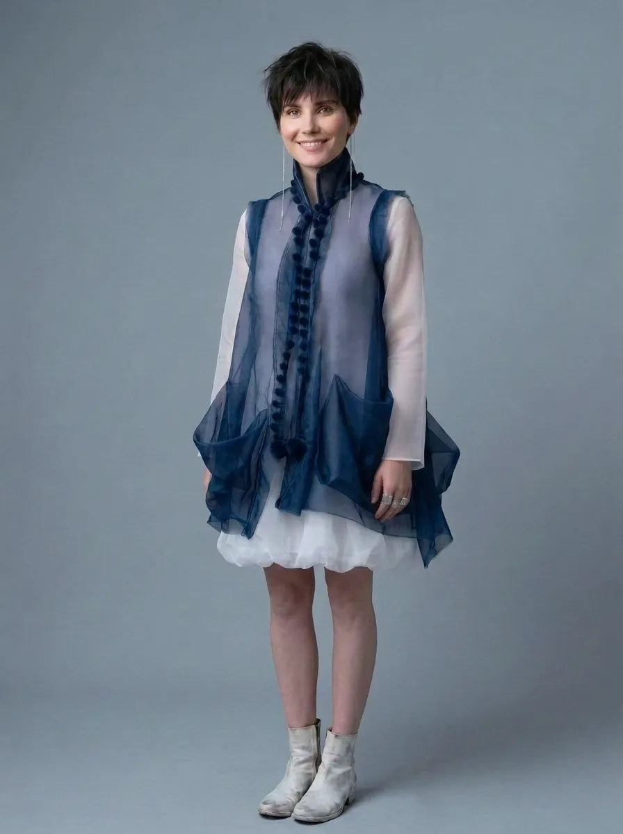 Woman wearing Shore Darling sustainable Chiffon Cloud Tunic & Bubble Skirt 2-Piece Set with a sheer dark blue vest and white dress