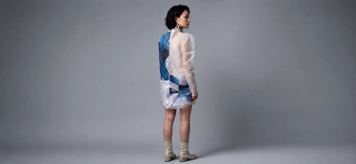 Woman wearing sustainable Shoredarling Sheer Panel Avantgarde Button-Up Tunic